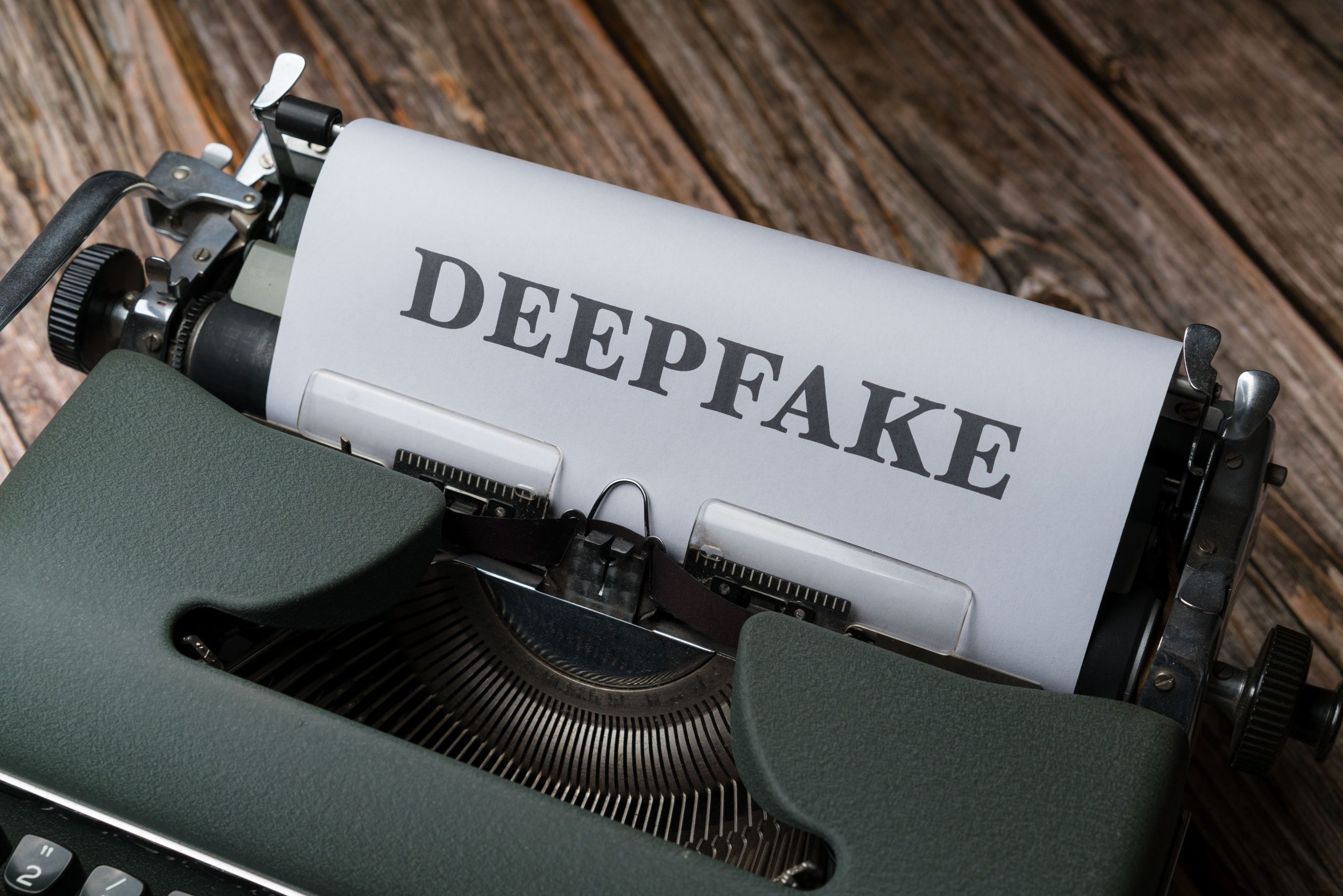 Close-up of a typewriter with the word Deepfake typed on paper, symbolizing AI-generated content detection